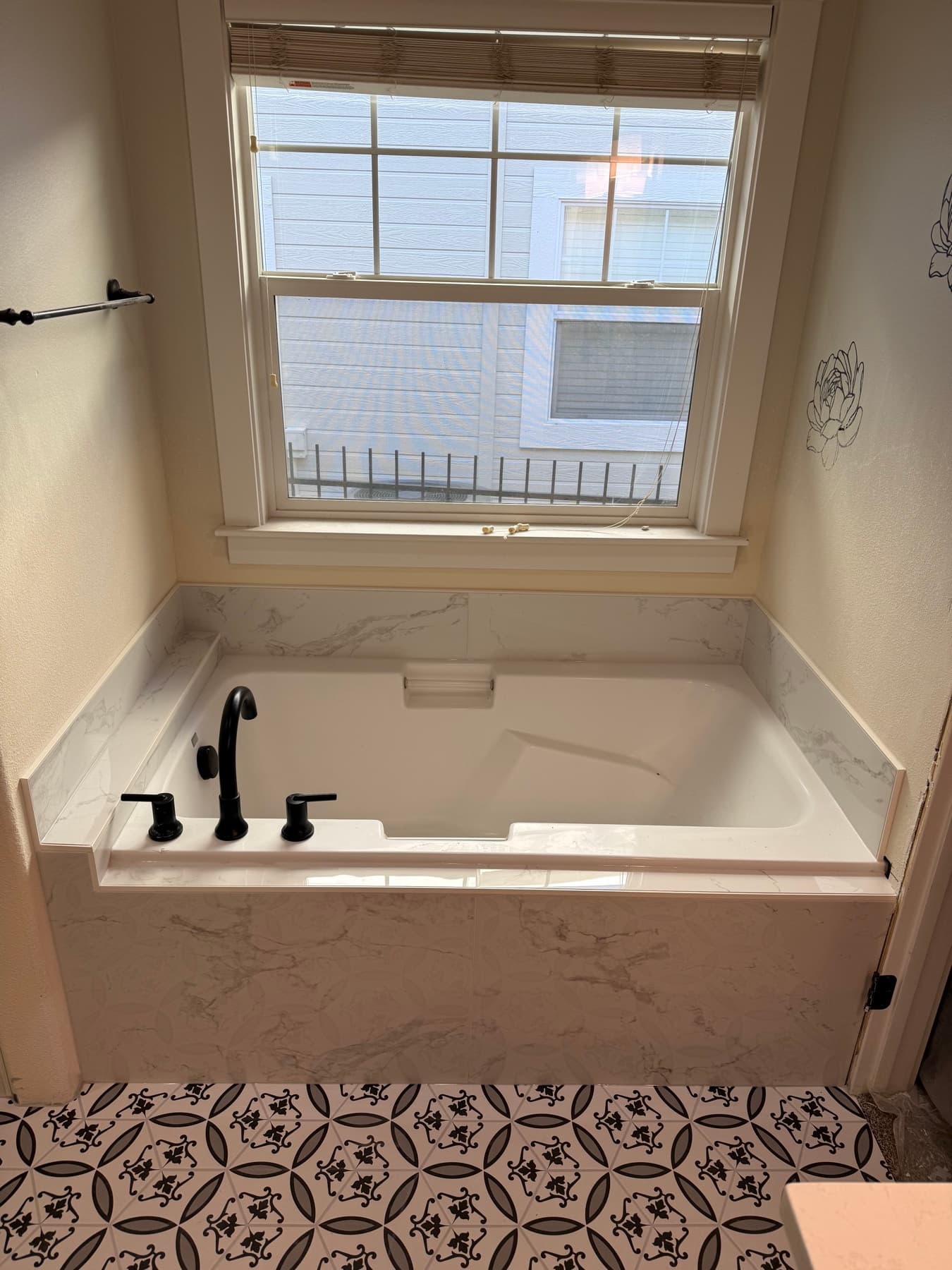 Bathroom tile remodel with a patterned accent and soaking tub
