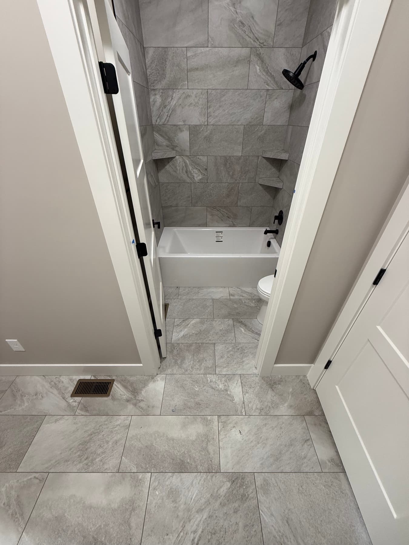 Freestanding soaking tub with a marble tile surround