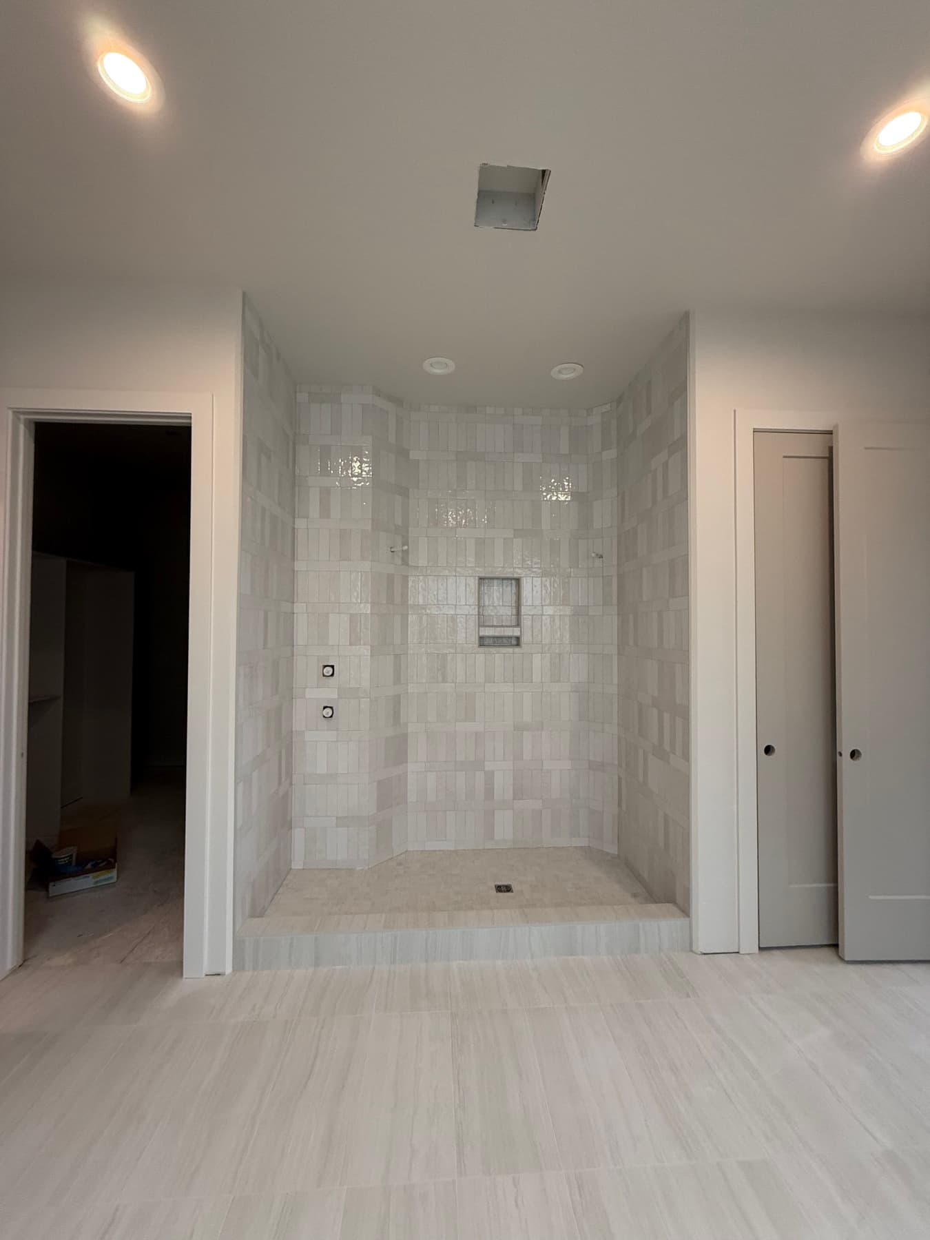 Marble shower with a built-in bench and niche