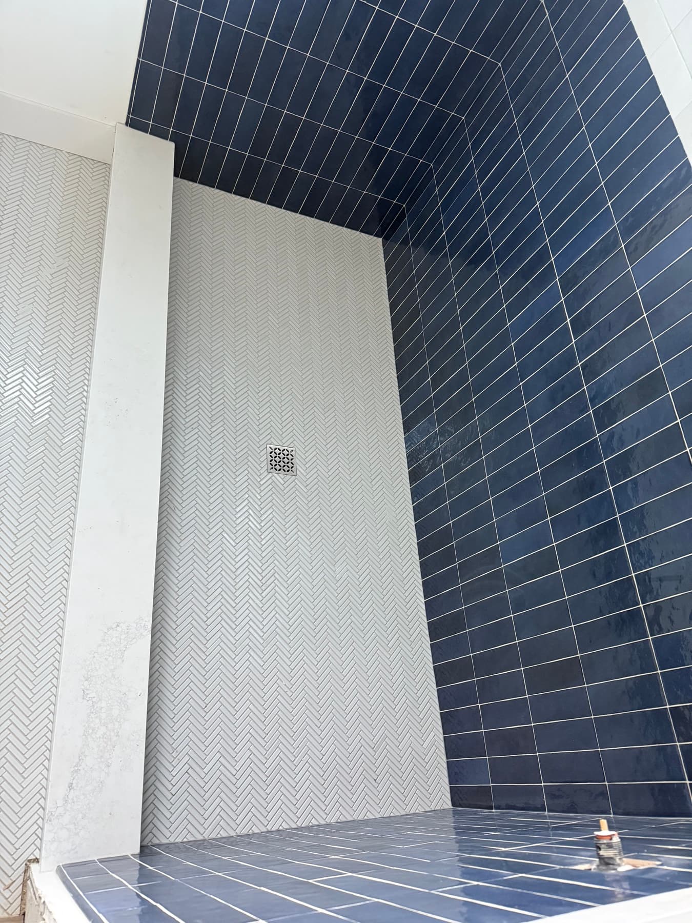 Navy and white tile walk-in shower